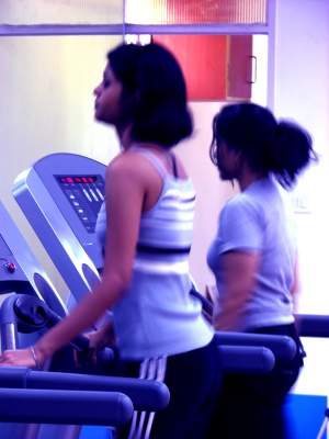 Two girls on a treadmill in a gym