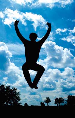 silhouette of a man jumping against sky