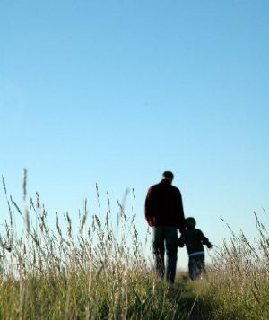 Father and son walking on the horizon