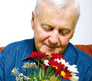Elderly person with flowers