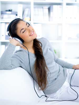 young happy woman listening blissfully to music