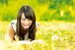 young woman reading in nature