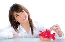 woman putting money in piggy bank