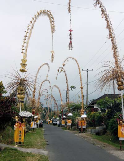 Bamboo poles with decorations line the street at bali