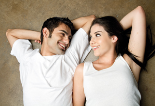 Couple laying down and smiling