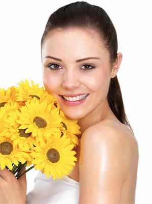 beautiful smiling girl with sunflowers