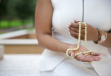 woman with prayer beads mala, mantra