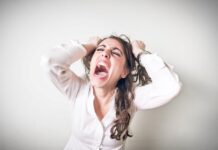 Hysterical woman pulling her hair in anger