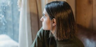 Why You Should Never Suppress Your Emotions + 6 Effective Strategies for Emotional Release Woman sitting alone looking through the window | Emotions concept