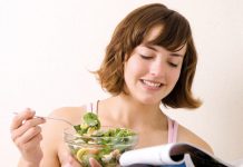 Woman having green salad