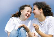 Two women laughing to each other