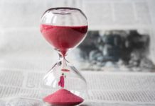 Meditation techniques for the busy hourglass with a miniature buddha embedded