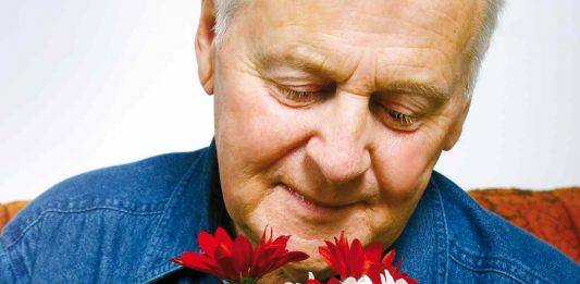 Elderly person with flowers