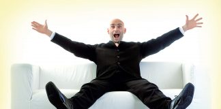 Happy man sitting on sofa
