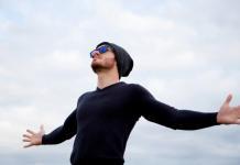 Man looking towards sky with arms outstretched | A seeker of spiritual growth