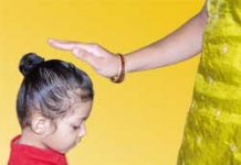 child receiving a blessing from a woman