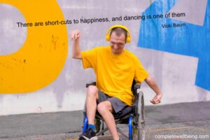 Happy disabled man dancing on wheelchair