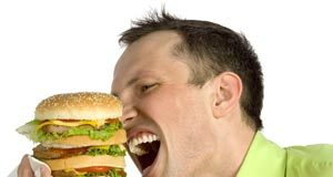 A fat-rich diet is a man’s enemy Man eating a large burger