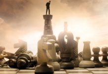 Man on top of one of the chess piece