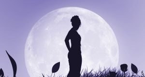 Woman's silhuoette against the full moon