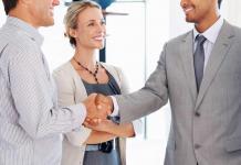 Man shaking hands with colleagues