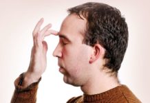 Man tapping finger between eyebrows