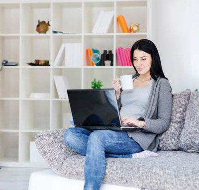 Women doing work in her laptop at her tidy house