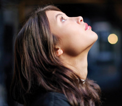Woman looking upwards for someone to believe