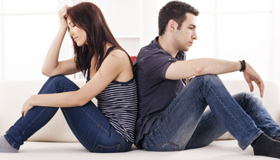 Man and woman sitting back to back having disappointment