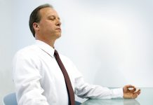 8 simple ways to bring yourself to the present moment Man sitting in meditation at office