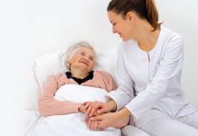 Why compassion is the best expression of spirituality Woman sitting next to an old lady who is bed ridden, compassion
