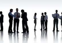 Here’s how you make the most of a networking event silhoutte of people standing and talking to each other in groups, networking