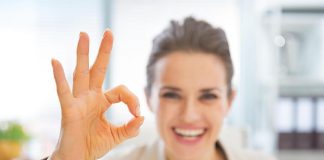 Happy woman gesturing OK with her hands