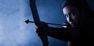 How to Be Mindful in Stressful Situations Woman aiming with an arrow | Concept of being mindful in stressful situations