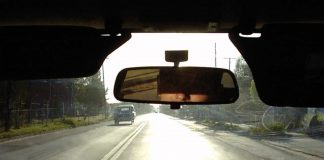 Man looking in the car mirror