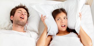 Couple in bed, man snoring and wife cannot sleep