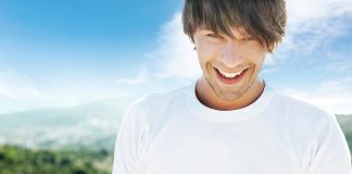 Young handsome man smiling in happiness