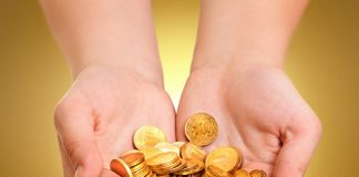hand holding gold coins