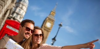 A guide to staying fit while travelling Travelling couple exploring city with map