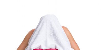 Essential treatment for sore throat A woman inhaling steam infused with essential oils