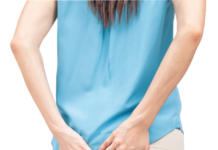 woman holding butt area, painful piles