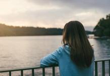 A woman enjoying being alone at a lake
