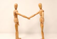 2 figures shaking hands, enemy