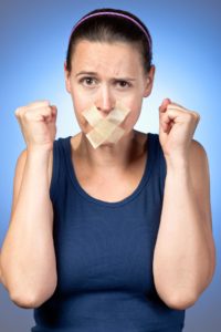 Woman with mouth taped