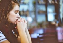 Younng women offering a silent prayer