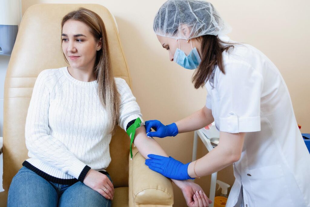 Woman giving sample for blood test
