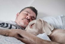 Man asleep with his dog