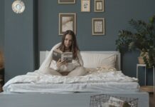 Woman reading a book in order to relax before going to bed