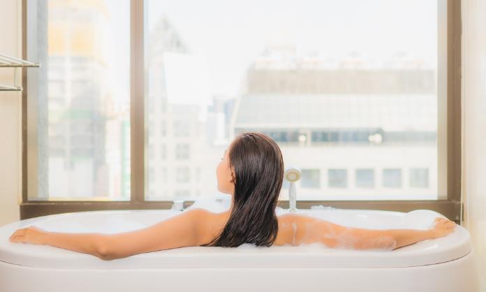 Woman relaxing in a bath tub