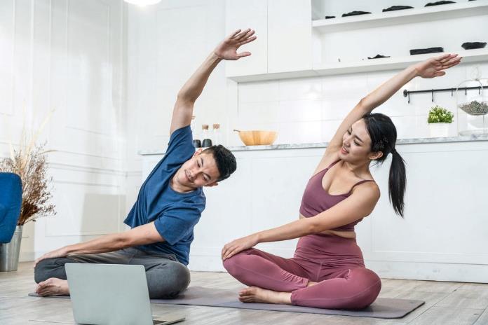 Couple practising yoga together